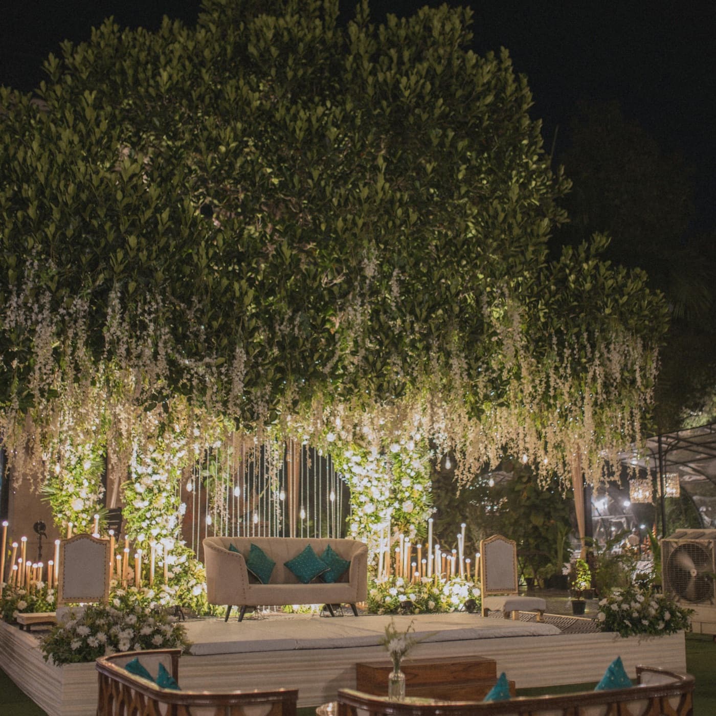 A wedding stage decorated with flowers and soft evening light